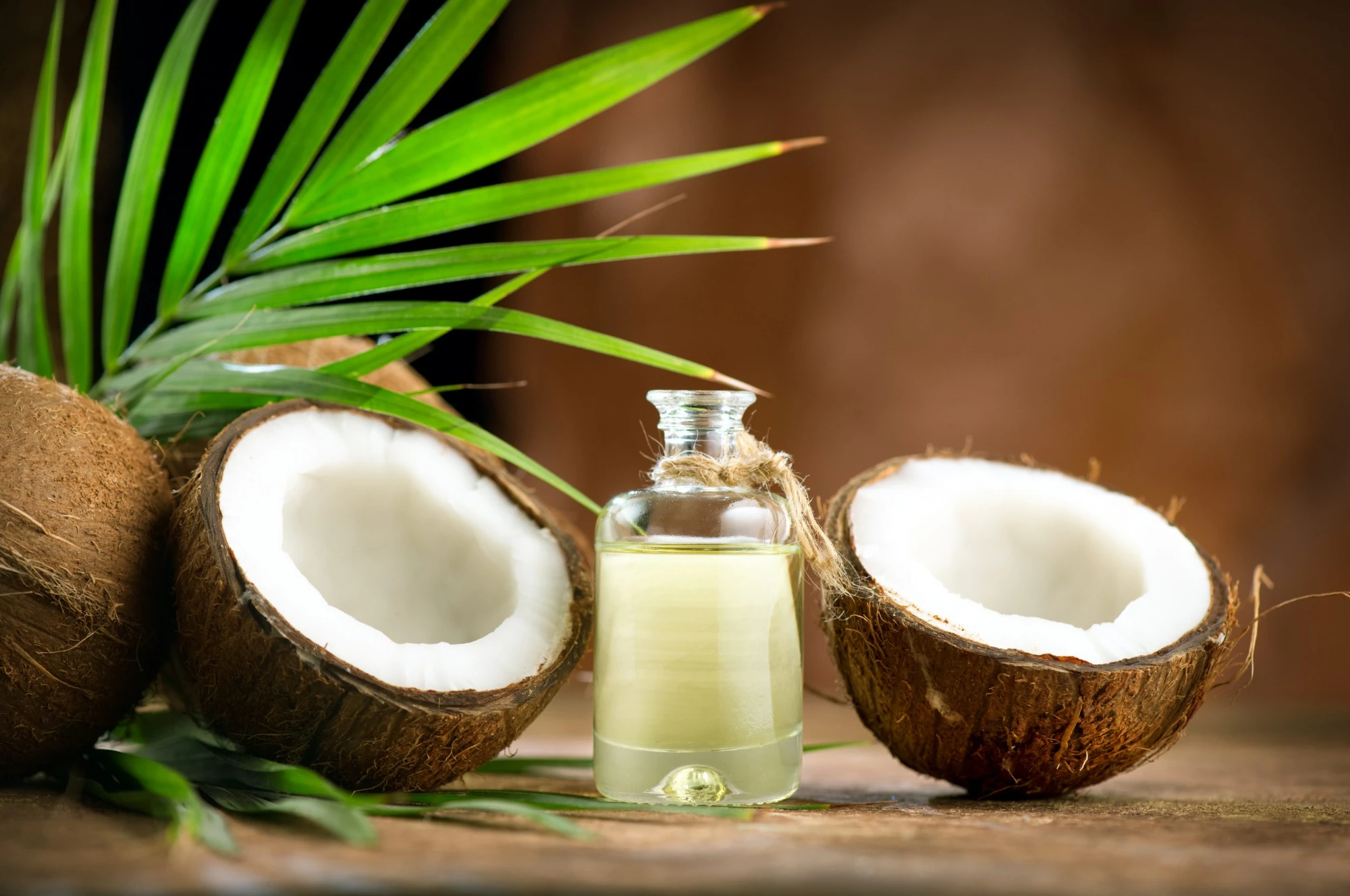 Coconut oil bottle with fresh coconut halves